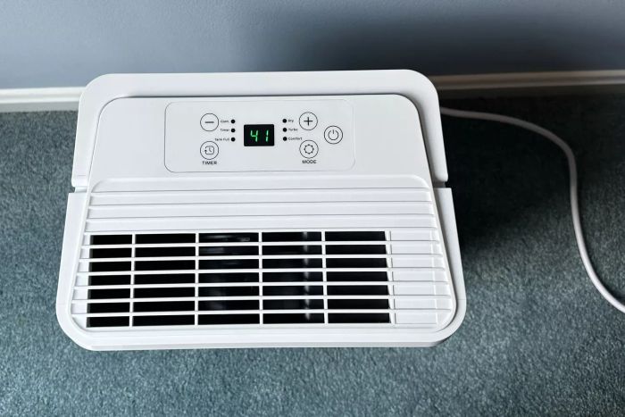 A top-down view of the Homelabs 8-Pint Dehumidifier positioned on a carpeted floor