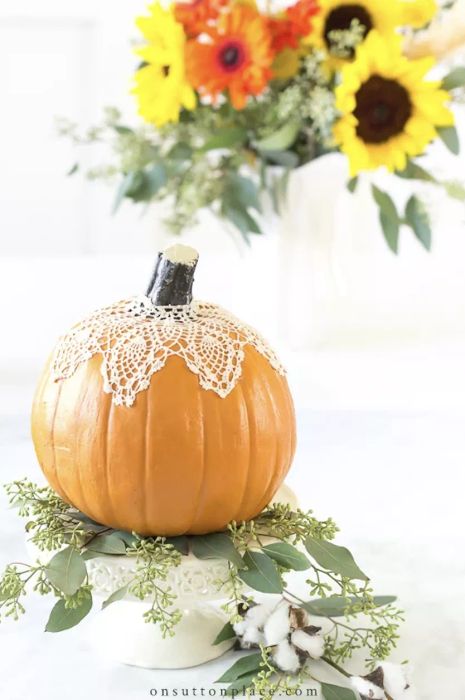 Lace-adorned pumpkins add a touch of elegance to your autumn decor, elevating the seasonal vibes with a beautiful and understated detail.