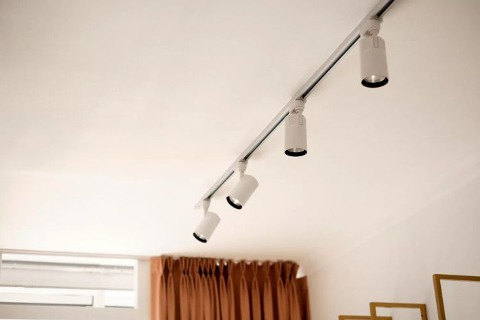 White ceiling spotlights mounted on a rail
