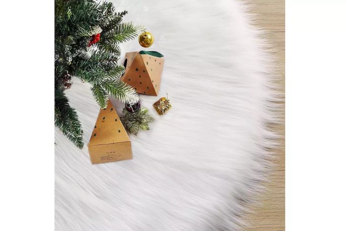 A white tree skirt made from wool and fur for a soft, snowy aesthetic.