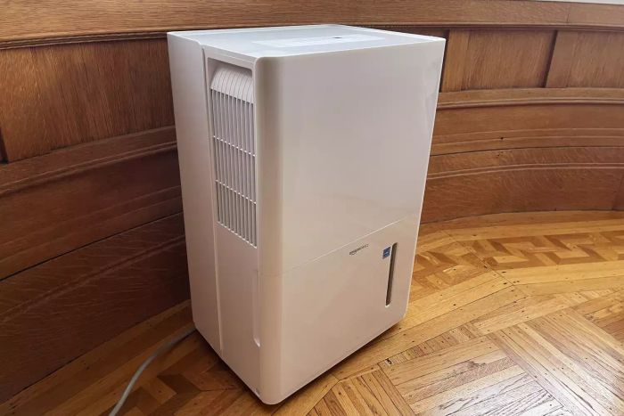 The Amazon Basics 35 Pint Dehumidifier showcased on a wooden floor