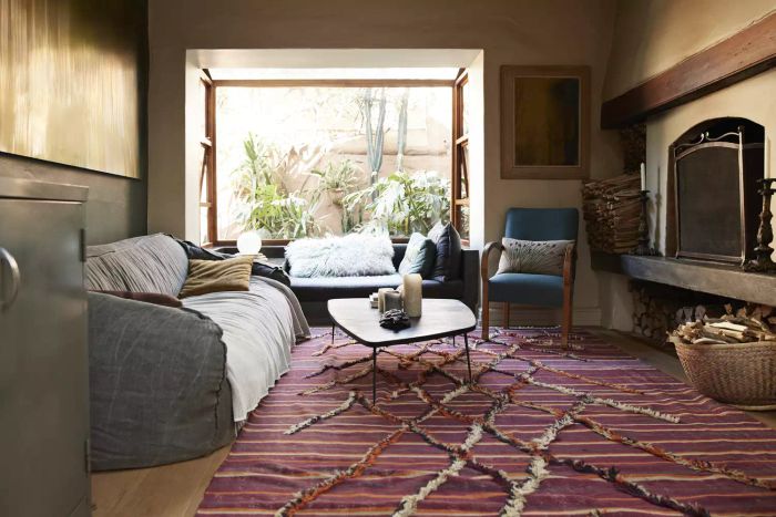 A living room featuring a vintage rug and a fireplace