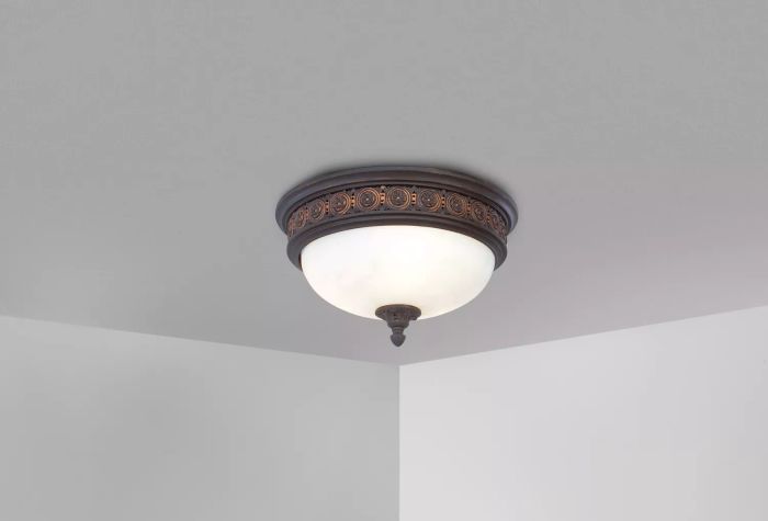 A ceiling-mounted light fixture against a backdrop of white walls