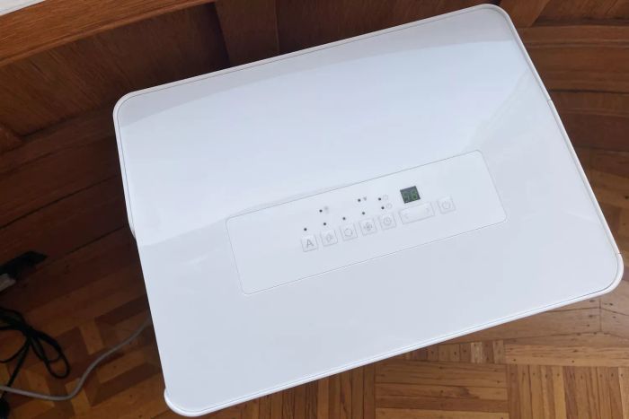 The control interface of the Amazon Basics 35 Pint Dehumidifier placed on a hardwood floor