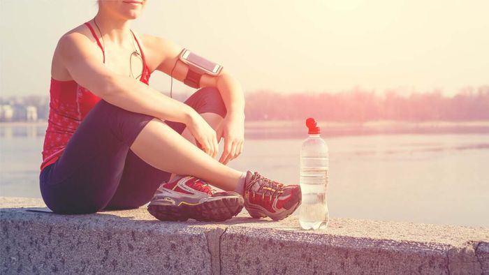 A runner taking a break against a wall