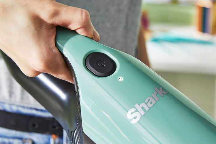 A close-up of a hand holding the Shark UltraCyclone Pro Cordless Handheld Vacuum.