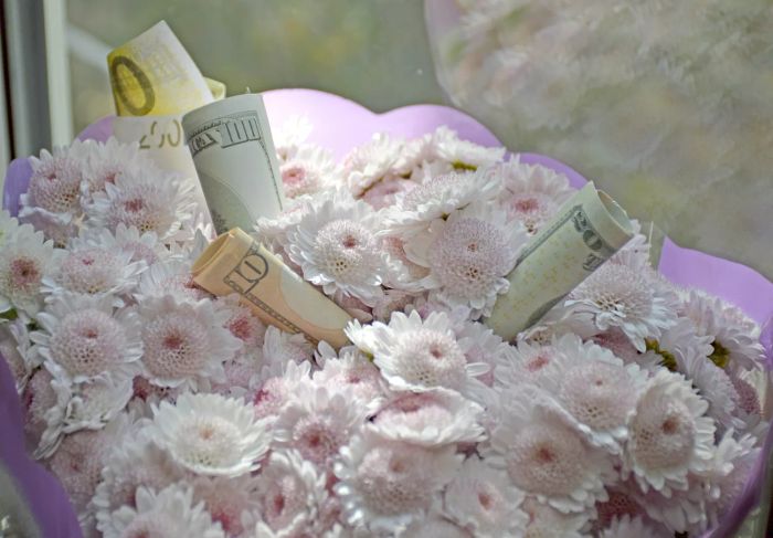 Present dollar bills as a bouquet