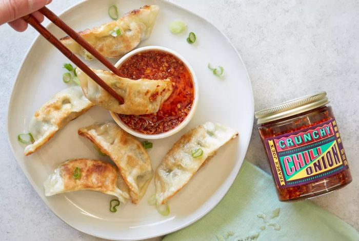 A photo of Trader Joe's Crunchy Chili Onion being used as a dip