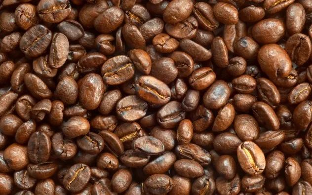 textured background: brown roasted coffee beans macro closeup