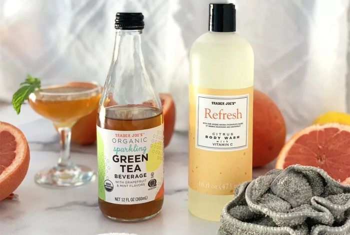 A photo of Trader Joe's Refresh Citrus Body Wash alongside a sparkling green tea beverage
