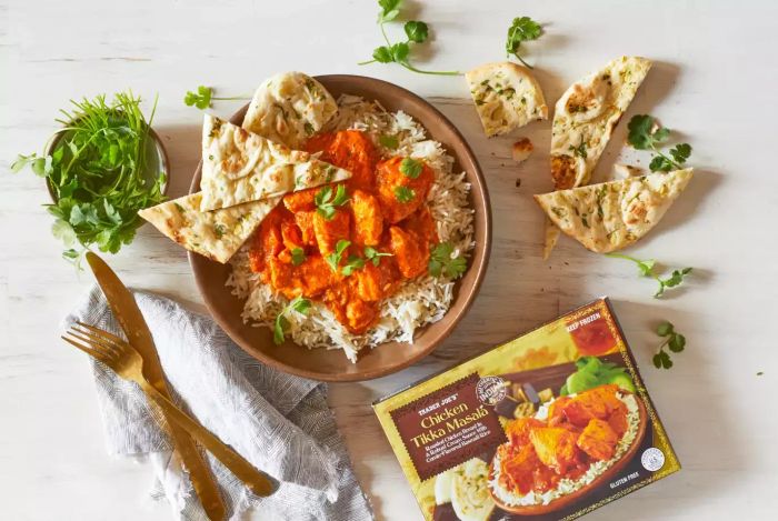 A photo of Trader Joe's Chicken Tikka Masala served with a bowl of rice