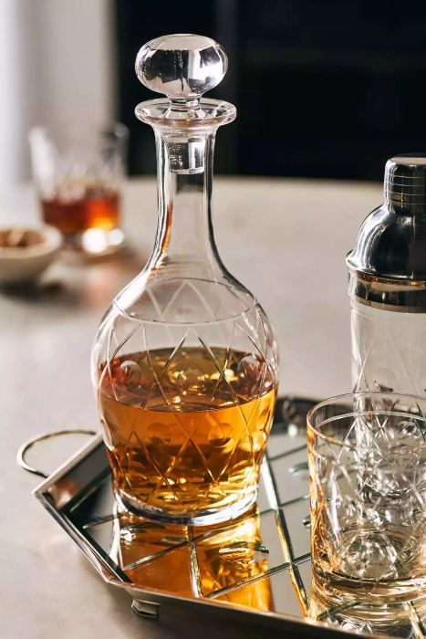 This elegant Anthropologie glass decanter is crafted to add sophistication to your home and elevate your barware collection.