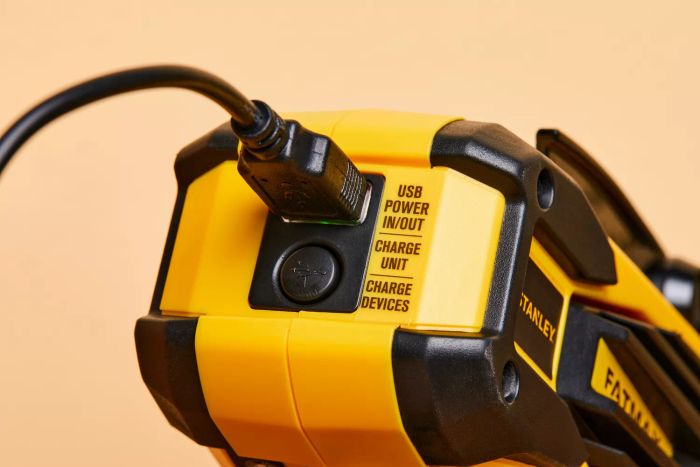 A close-up view of the charger connected to the Stanley Fatmax Rechargeable Lithium Ion LED Spotlight Flashlight.