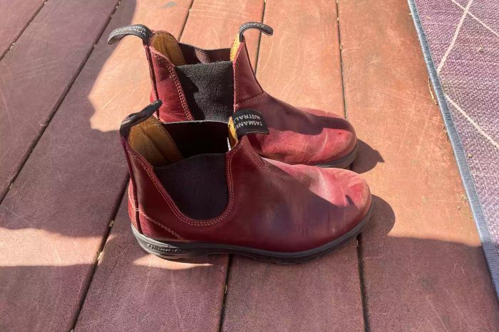 A pair of Blundstone #1352 Women's Originals High Top Boots placed on a wooden table