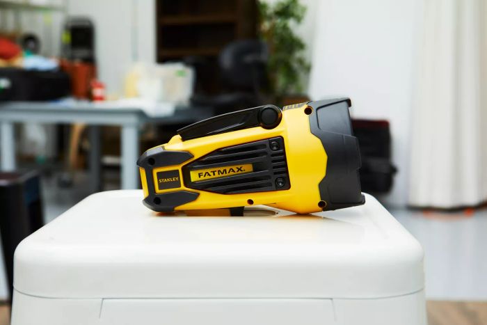 The Stanley Fatmax SL10LEDS Rechargeable Spotlight displayed on a white stool.