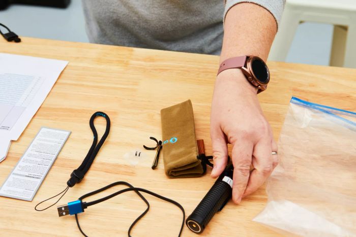 A person holding the Olight S2R Baton II USB Magnetic Rechargeable Flashlight