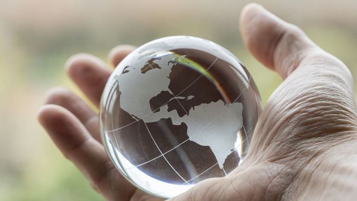 A pair of hands cradling the globe