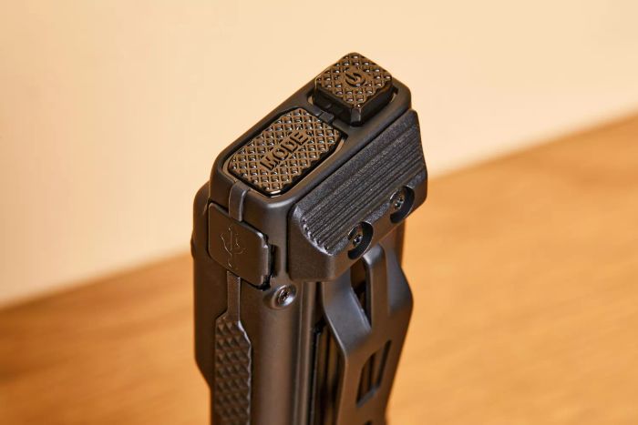 A close-up view of the buttons and ports on the Nitecore EDC27 Ultra Slim Flashlight.