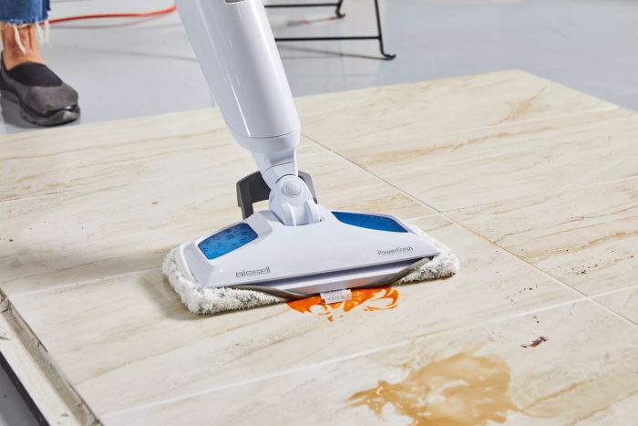 Bissell 1940 PowerFresh Scrubbing & Sanitizing Steam Mop removing spills from a tiled floor