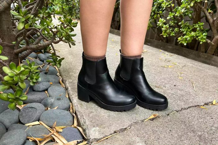 A person strolls outdoors wearing the Soda Jaber Boot