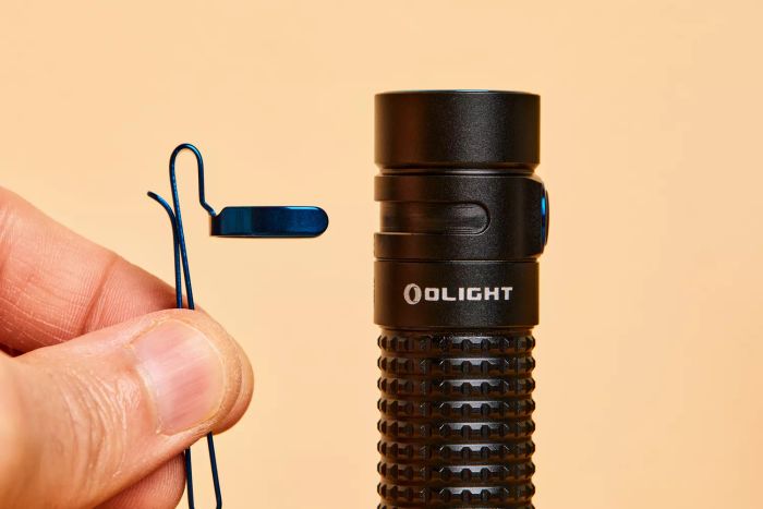 A detailed view of the Olight S2R Baton II USB Magnetic Rechargeable Flashlight's grip and clip