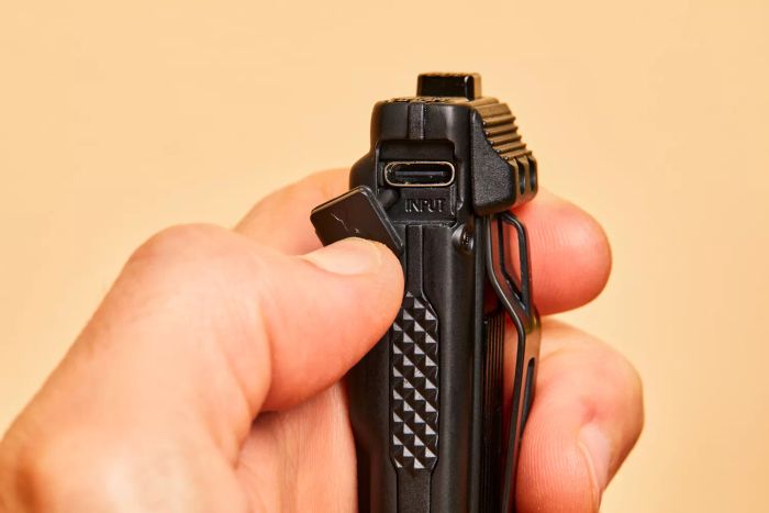 A close-up view of the charging port on the Nitecore EDC27 Ultra Slim Flashlight.