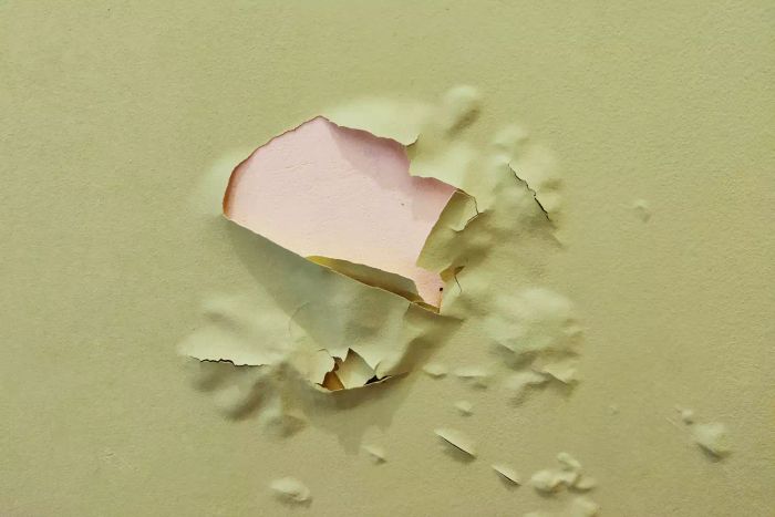green paint peeling off the wall