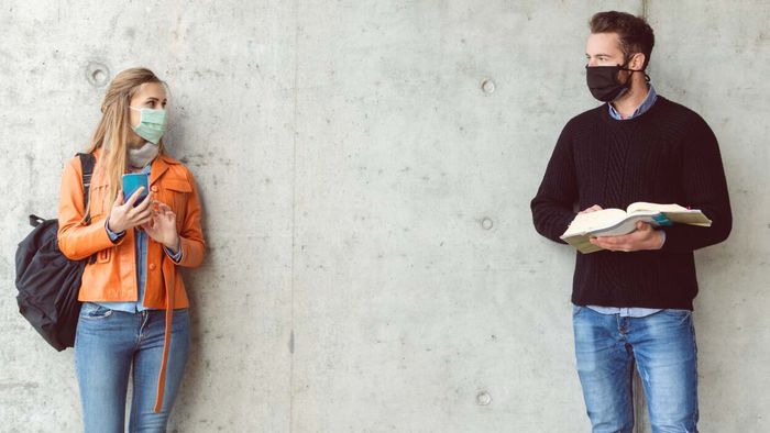 Two individuals wearing face masks