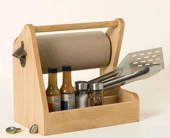 a caddy stocked with grill tools, spices, and paper towels
