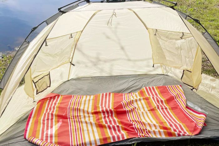 Oileus XL Beach Tent set up on grass next to a pond.