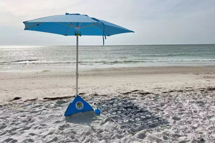 The beachBUB All-In-One Beach Umbrella System set up on the sandy beach