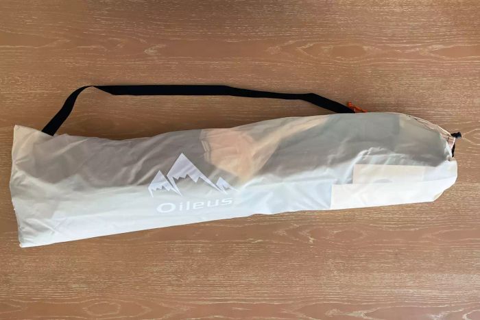 Oileus XL Beach Tent with its carrying case resting on a wooden surface