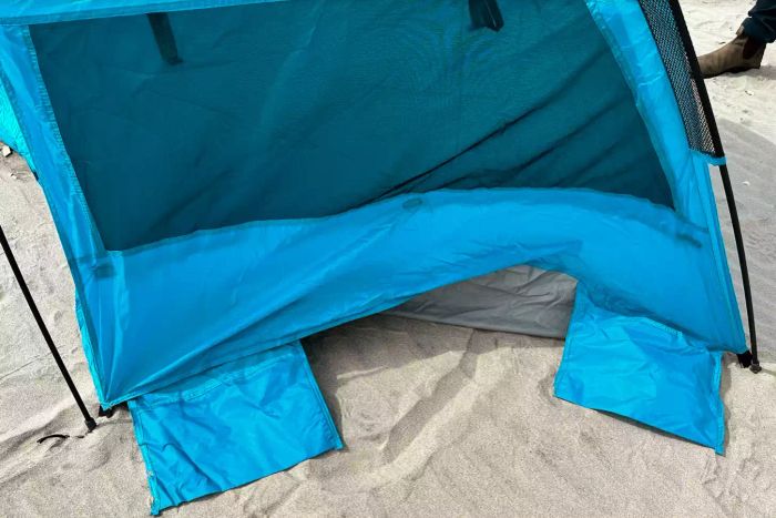 A close-up of the Pacific Breeze Easy Setup Beach Tent set up on the sand