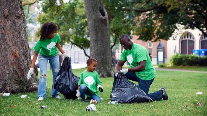 a family cleaning up trash in a park