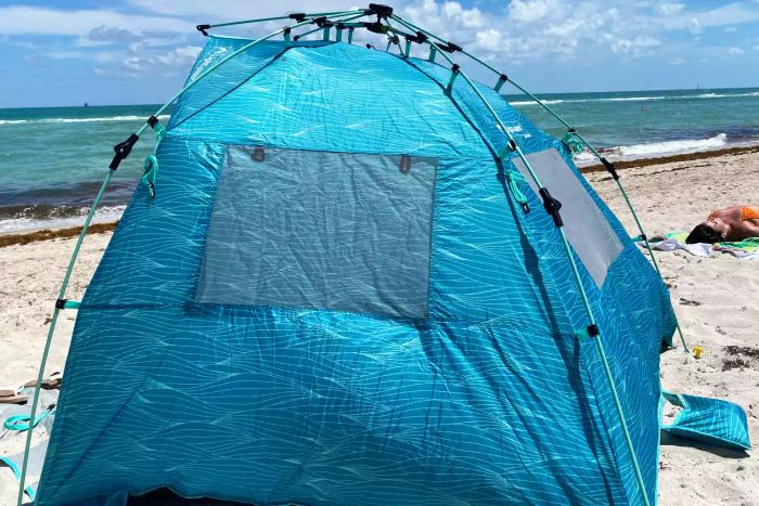 The Lightspeed Outdoors Quick Cabana Beach Tent positioned on the beach, showcasing its design.