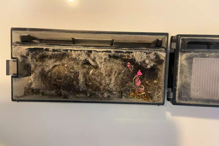 The dirty canister of the Eufy Clean X9 Pro Robotic Vacuum after use