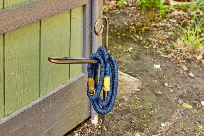 TheFitLife Flexible and Expandable Garden Hose positioned on a hose stand for display.