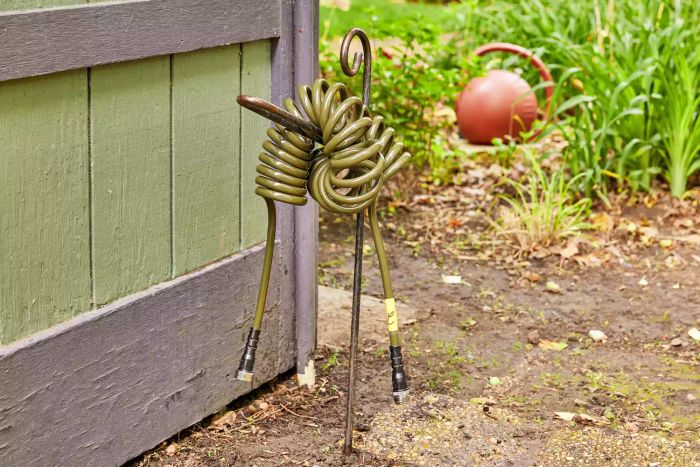 Water Right Coil Garden Hose resting on a hose stand in a garden