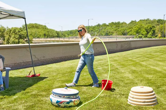 A person testing the Flexzilla Zillagreen Garden Hose in a grassy area