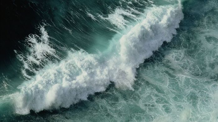 Ocean waves shimmering in turquoise blue.