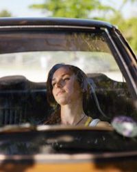 A woman seated inside a car