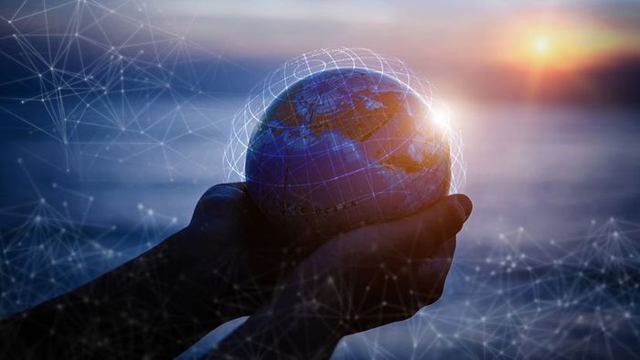 Tiny hands gripping a globe