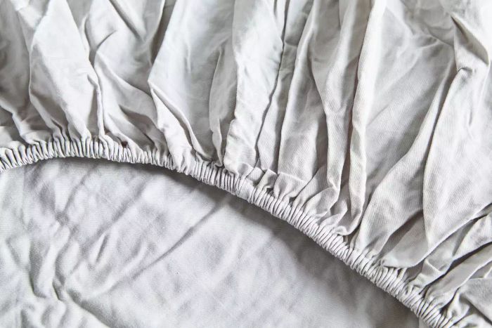 A close-up of the elastic band on the Quince Linen Bamboo Sheet Set.
