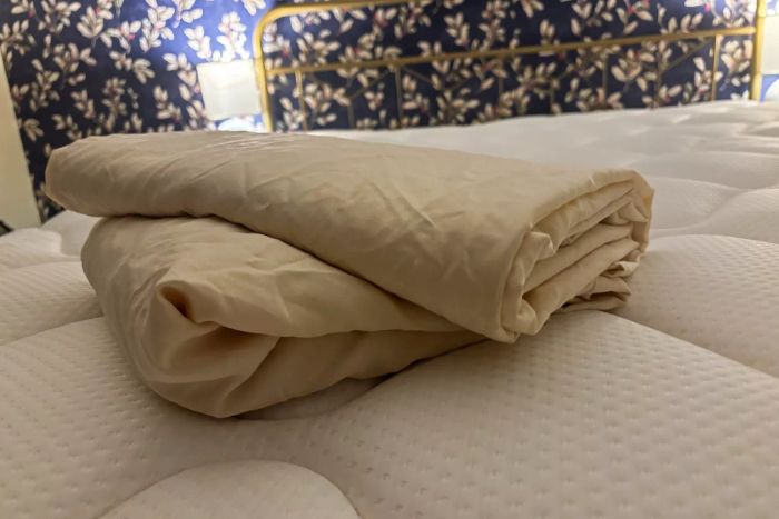 The Cosy House Collection Luxury Bed Sheets neatly folded on a mattress.