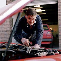 A man repairing his car engine