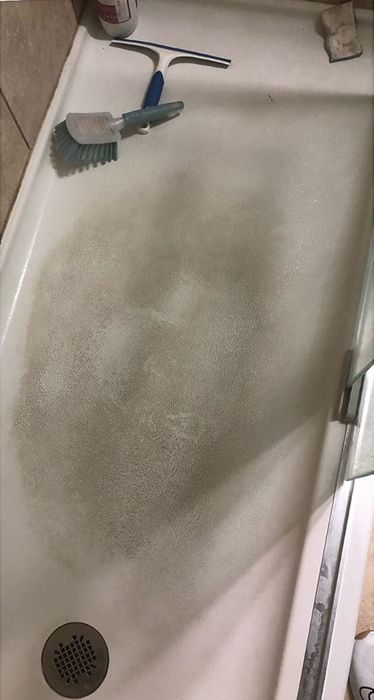A reviewer's before photo of a heavily soiled shower floor