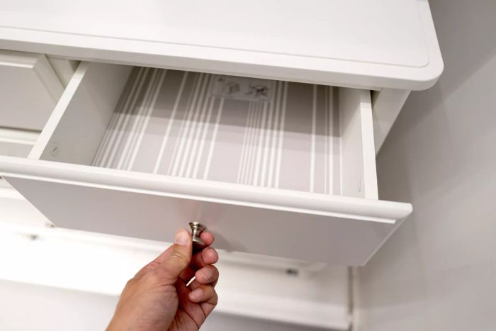 A wallpapered drawer can be an unexpected but delightful design touch. If you’ve got leftover peel-and-stick wallpaper or a favorite pattern you’re unsure how to use, consider lining your drawers or shelves. This is especially effective for older, yellowed furniture. The process is simple: just clean the surface well before applying the wallpaper.