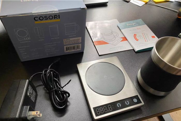 Components of the Cosori Original Coffee Warmer and Mug laid out on a table
