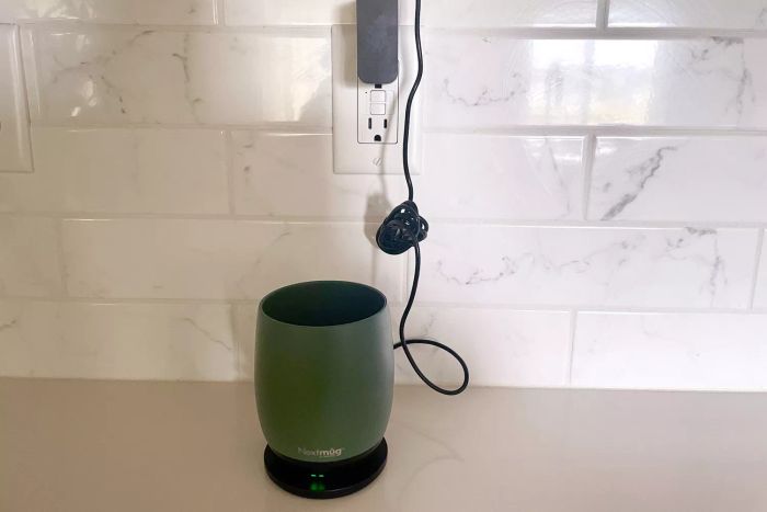 Nextmug Temperature-Controlled Self-Heating Coffee Mug connected to a power outlet