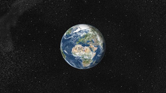 A satellite image of Earth reveals Europe and Africa, both covered by clouds.
